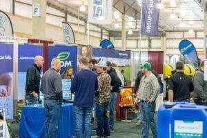Visitors talk with exhibitors at the Nebraska Ag Expo